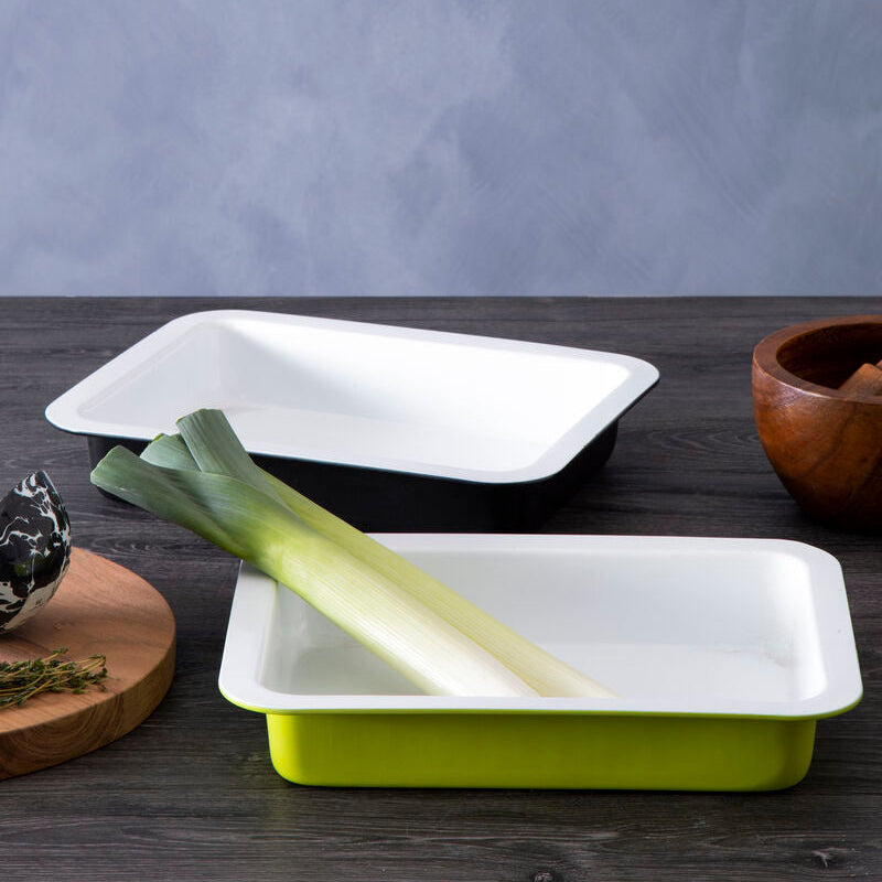 Two rectangular ceramic dishes on a wooden surface with a gray background