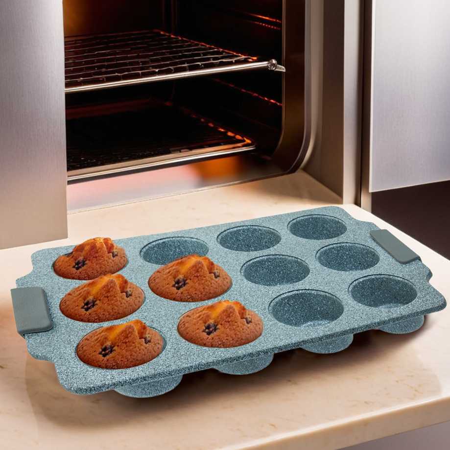 Blue muffin tray with baked muffins on a kitchen counter next to an open oven.