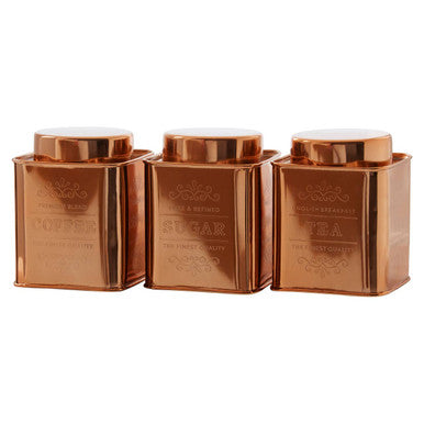 Three copper tea canisters on a white background