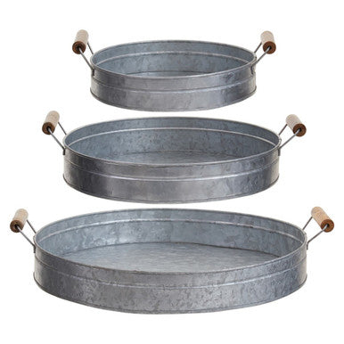Set of three oval metal trays with handles on a white background