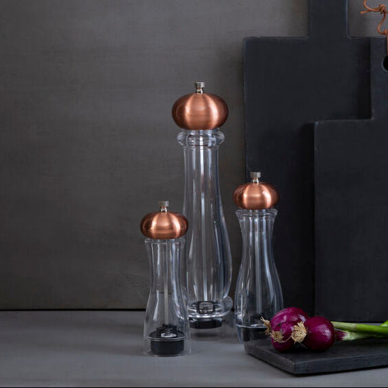 Black cutting boards with copper accents on a gray background