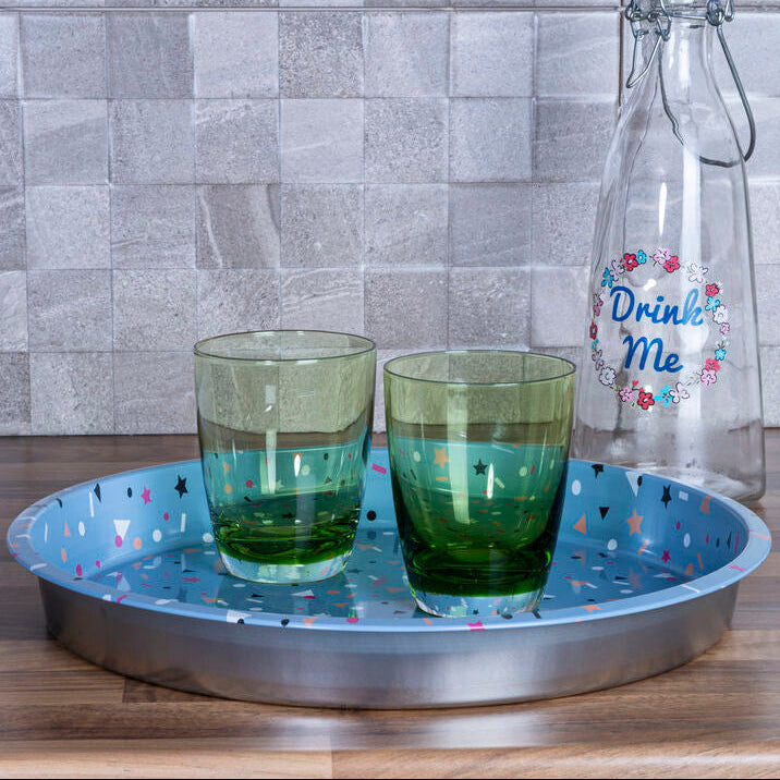 Two green tumblers on a blue tray with a &