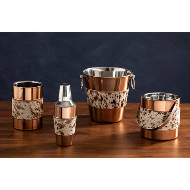 Set of copper and marble-patterned barware on a wooden surface with a dark background