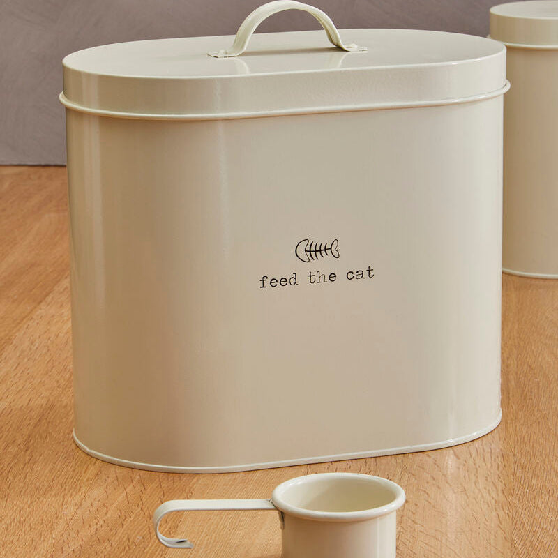 Beige cat food storage container with a small scoop on a wooden floor.