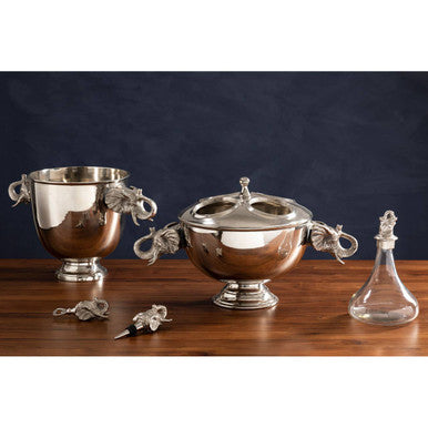 Set of silver trophies on a wooden surface with a dark background