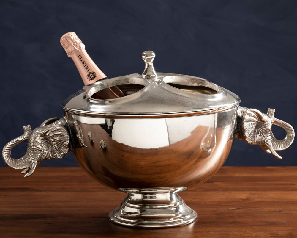 Silver ice bucket with elephant handles on a wooden surface
