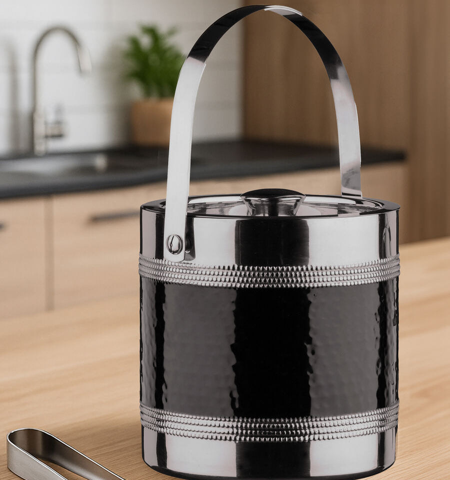 Black ice bucket with silver handle and trim on a kitchen counter