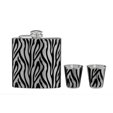 Flask and two shot glasses with zebra pattern on a white background