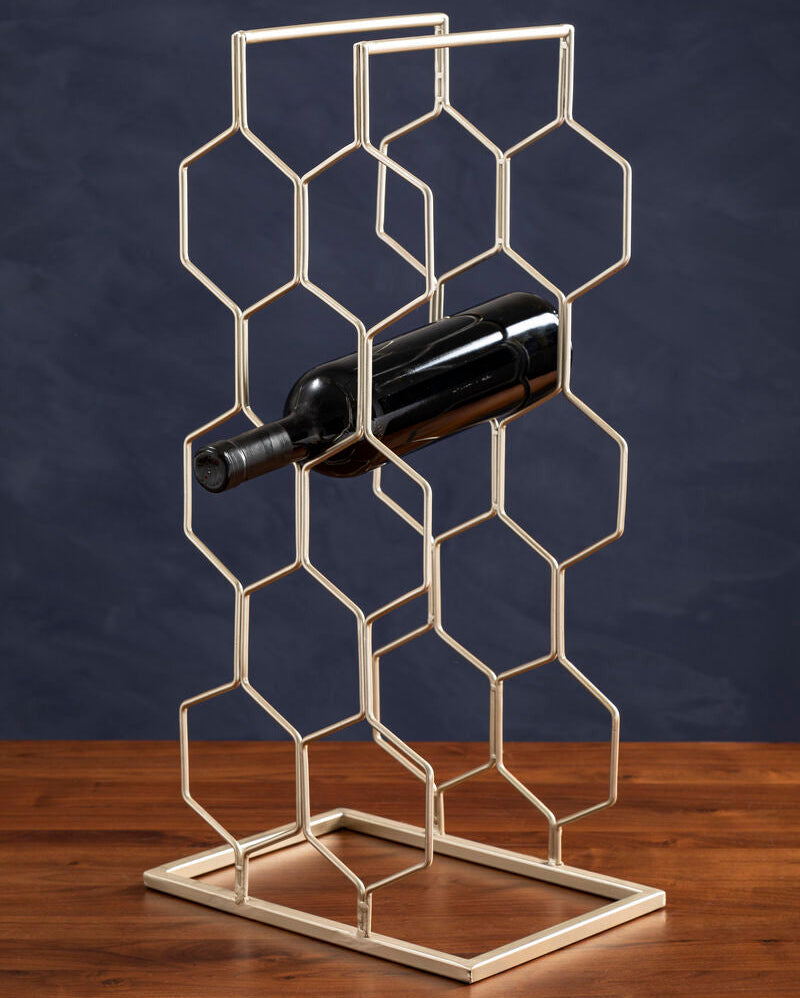 Metal wine rack with a bottle on a wooden surface against a dark background