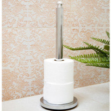 Toilet brush with holder on a bathroom counter against a tiled wall.