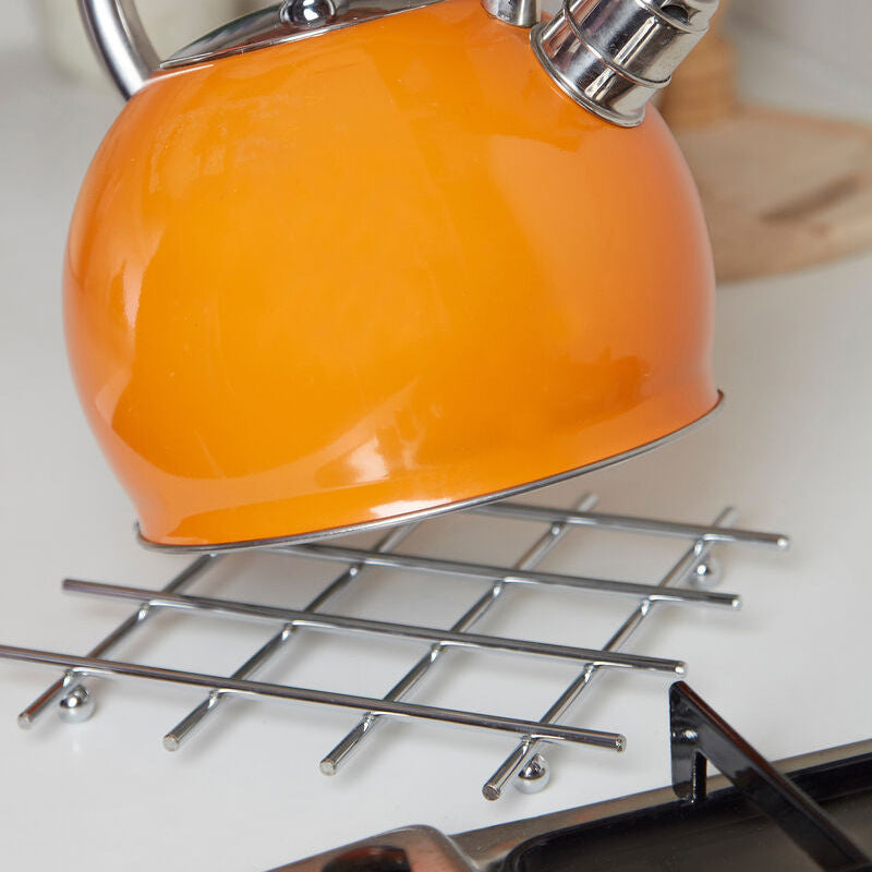 Orange kettle with a silver whistle on a stove