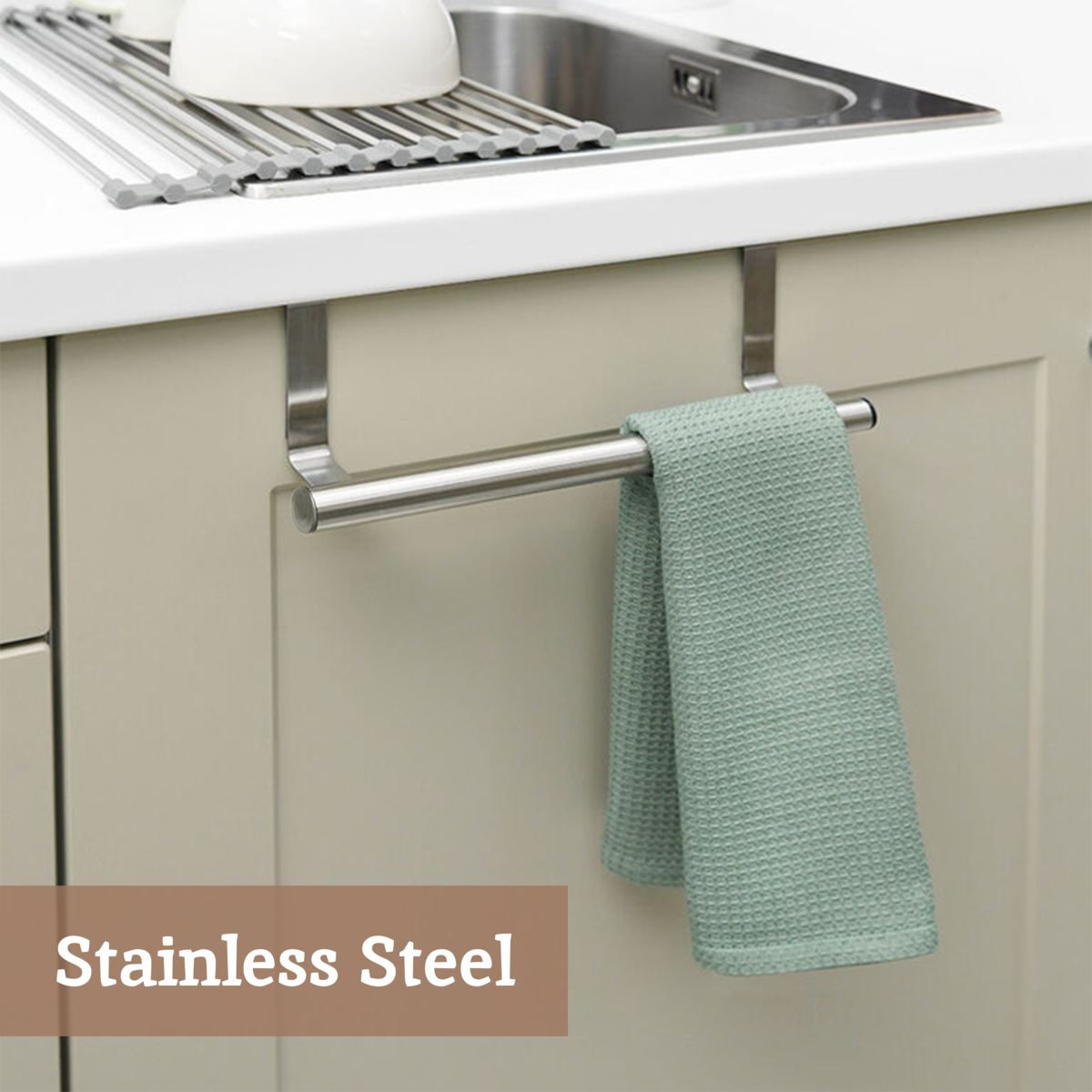 Kitchen sink area with a green towel hanging on a stainless steel rack, labeled &
