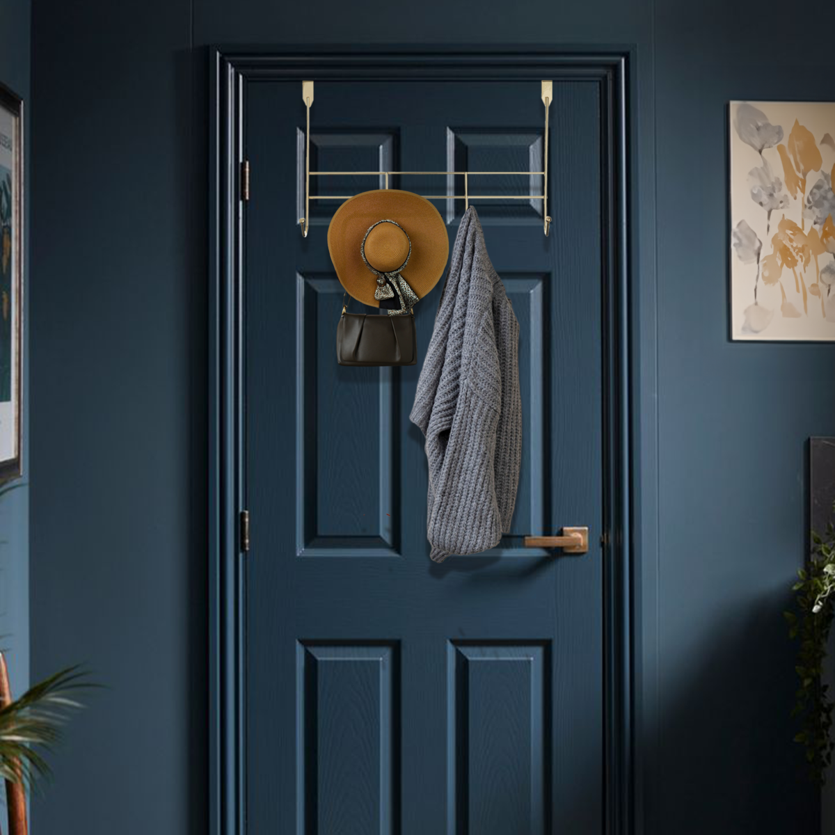 Blue door with coat rack holding a hat, bag, and coat against a blue wall.