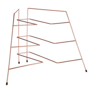 Copper metal magazine rack on a white background