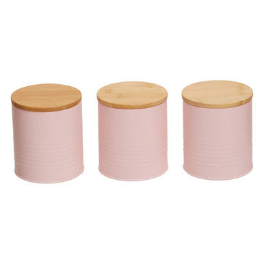 Three pink canisters with wooden lids on a white background