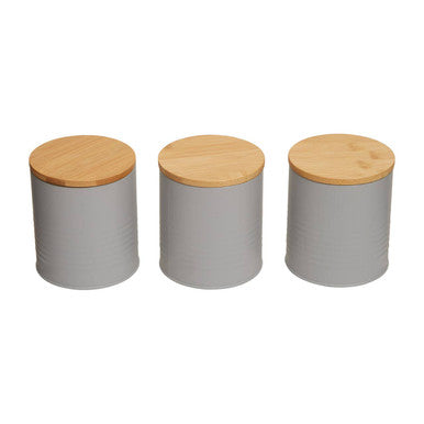 Three gray canisters with wooden lids on a white background