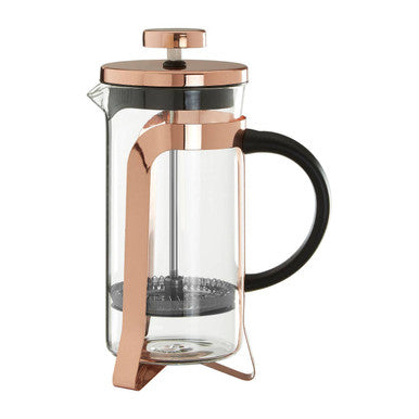 Rose gold French press coffee maker with a clear glass body and black handle on a white background