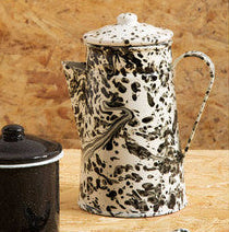 Decorative teapot with a leopard print design on a wooden surface
