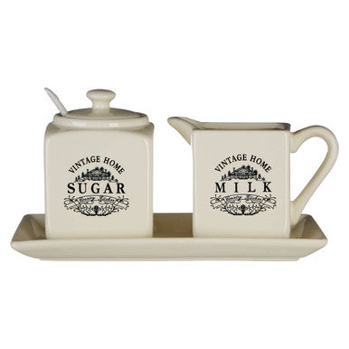 Vintage-style sugar and milk containers with a tray on a white background