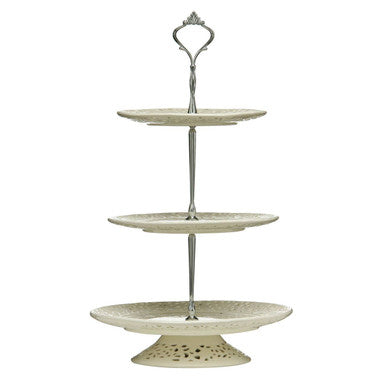 Three-tiered ceramic stand with decorative metal top on a white background