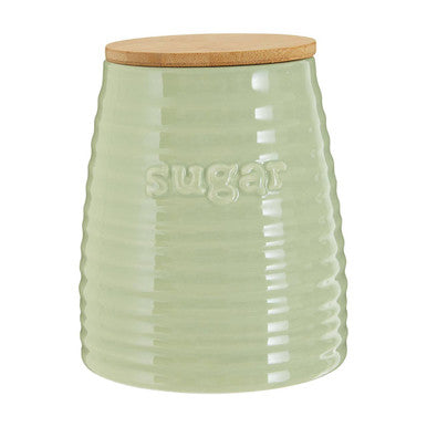 Green ceramic sugar jar with a wooden lid on a white background