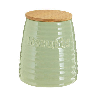 Green ceramic cookie jar with a wooden lid on a white background