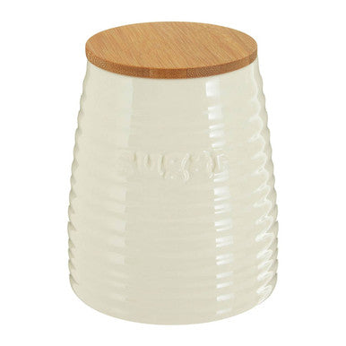 White textured jar with a wooden lid on a white background
