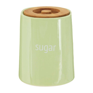 Green sugar container with a wooden lid on a white background