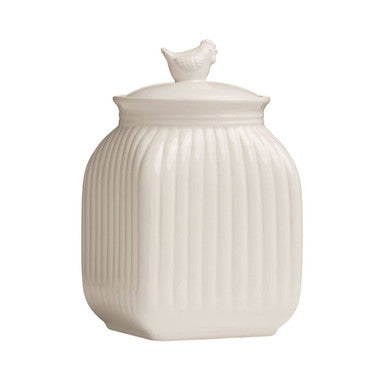 White ceramic jar with ribbed design and bird-shaped lid on a white background