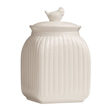 White ceramic jar with ribbed design and chicken lid on a white background