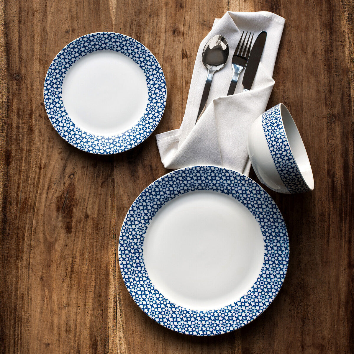 Dinnerware set with blue and white pattern on a wooden table