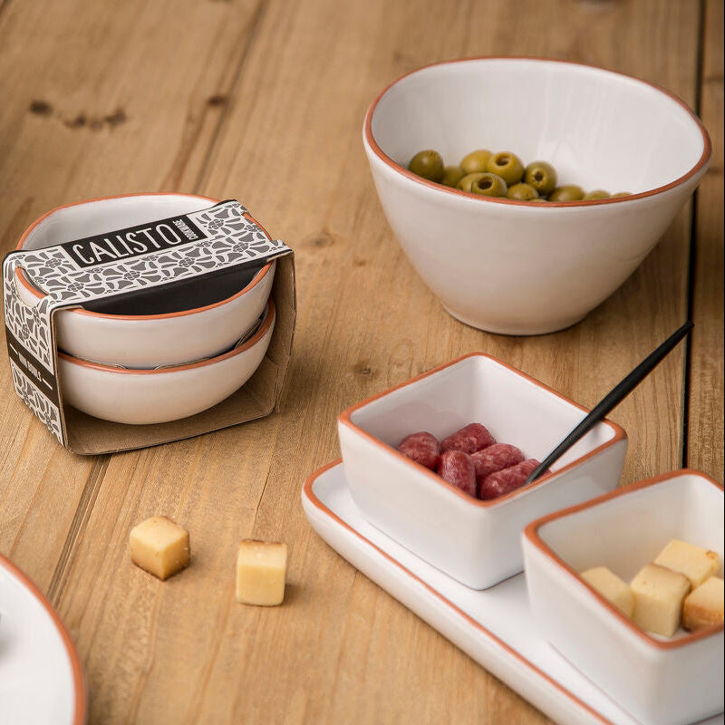 Calista ceramic bowls on a wooden table with salads and snacks.