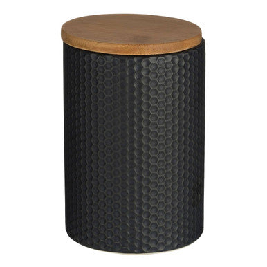 Black textured storage jar with a wooden lid on a white background
