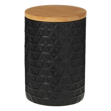 Black textured storage jar with a wooden lid on a white background