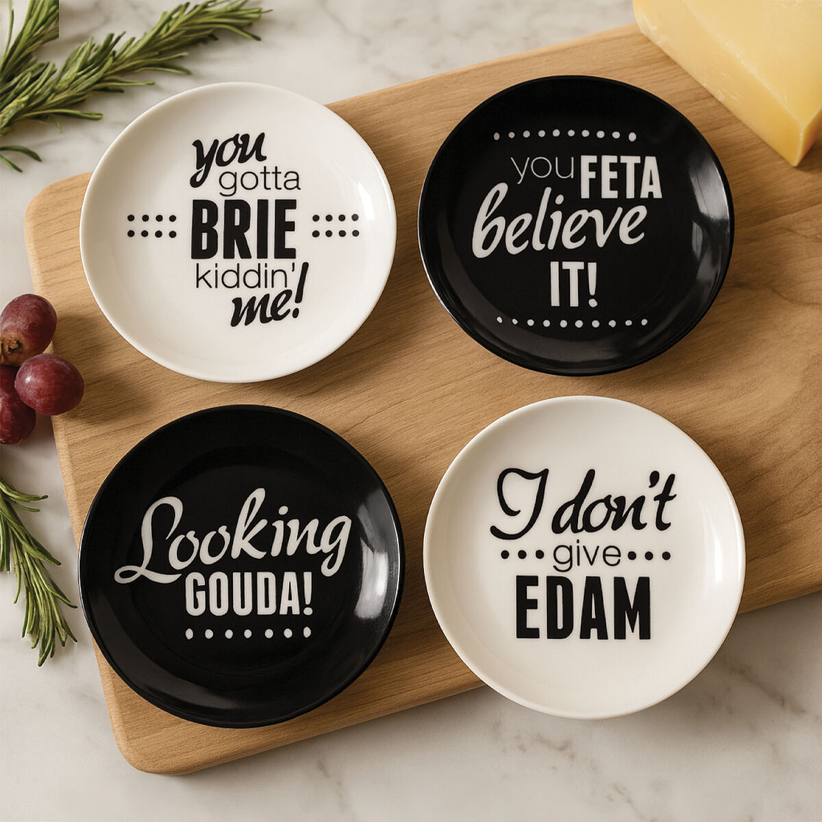 Four ceramic plates with humorous cheese-themed sayings on a wooden board.