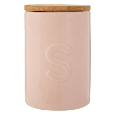 Pink ceramic jar with a wooden lid on a white background