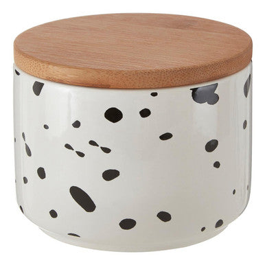 Ceramic container with black dot pattern and wooden lid on a white background