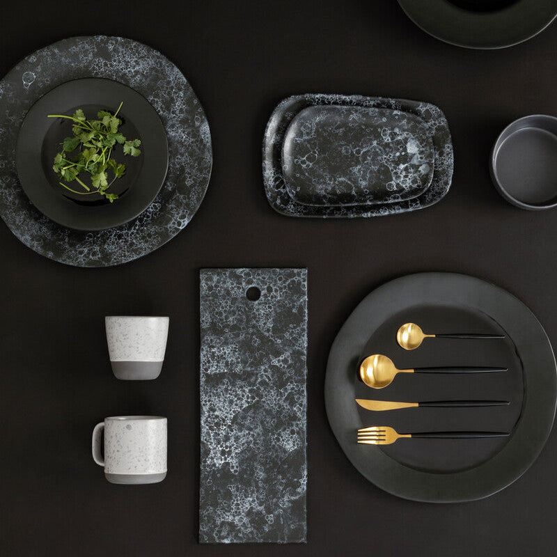 Dark gray ceramic tableware set on a black background
