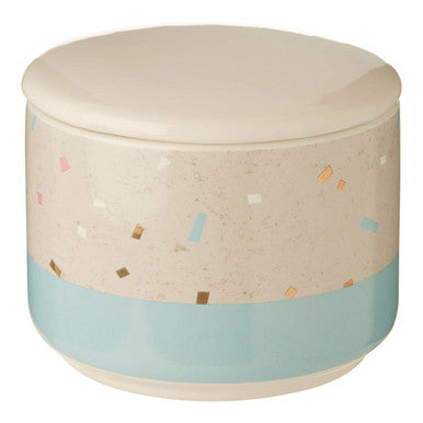 Round storage ottoman with a light blue bottom and confetti pattern on the top, on a white background.
