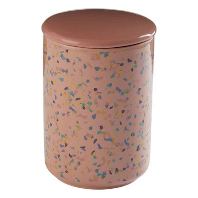 Pink cylindrical container with a speckled pattern on a white background
