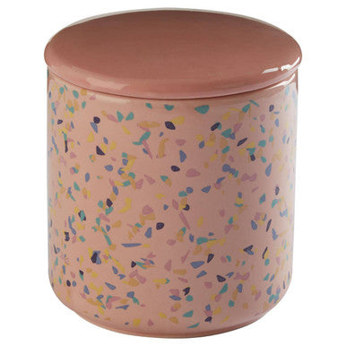 Pink ceramic jar with colorful speckles and a matching lid on a white background