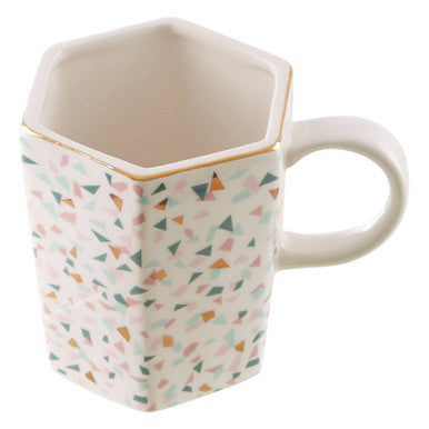 Hexagonal mug with geometric pattern on a white background