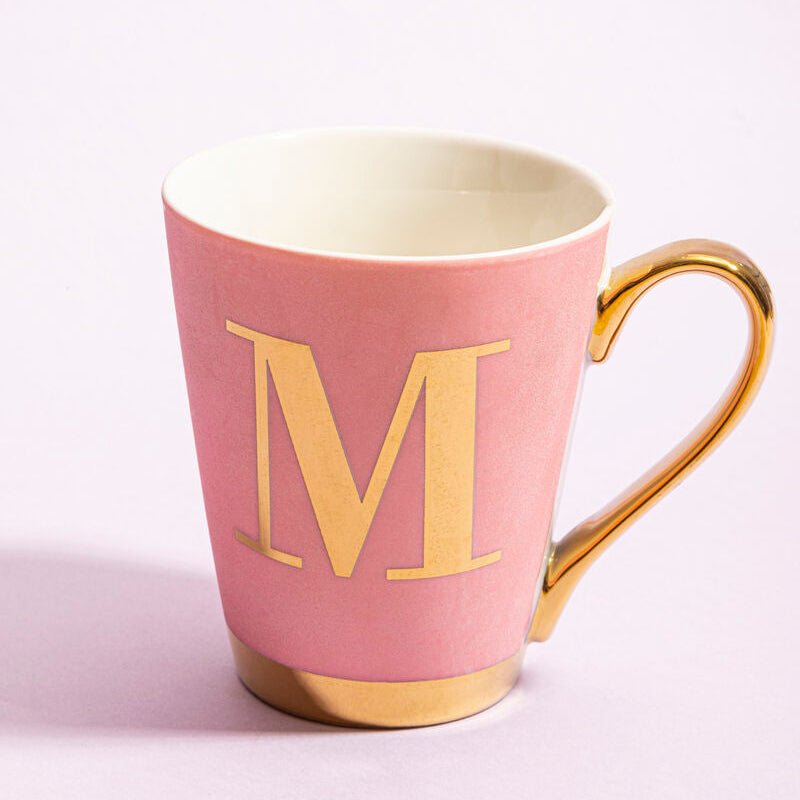 Pink mug with gold handle and letter &