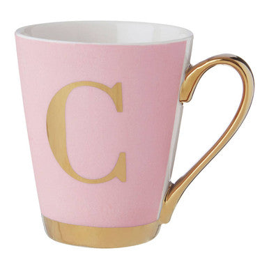Pink mug with gold handle and letter &