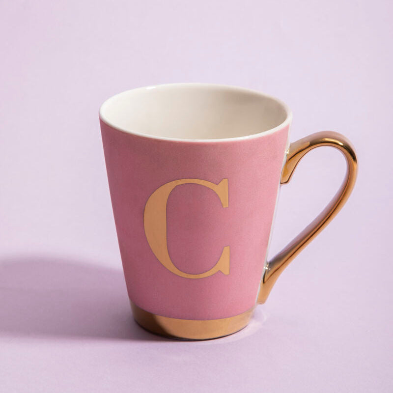 Pink mug with gold handle and letter &