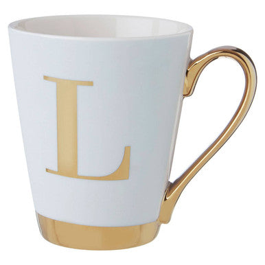 White mug with gold handle and letter &