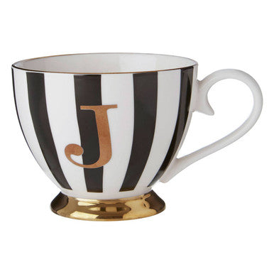 Mug with black and white stripes and a gold letter &