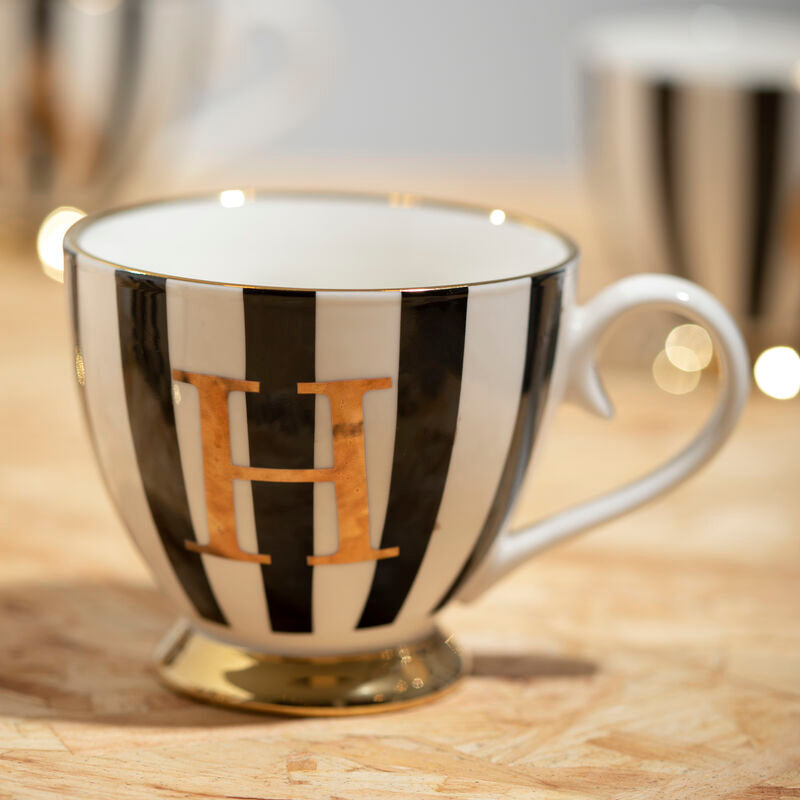 Black and white striped mug with gold letter &