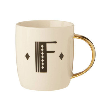 Beige mug with gold handle and decorative letter &