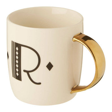 Beige mug with gold handle and decorative letter &